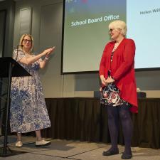 HR Manager claps for retiree on stage