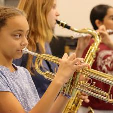 Female student playing new instrument